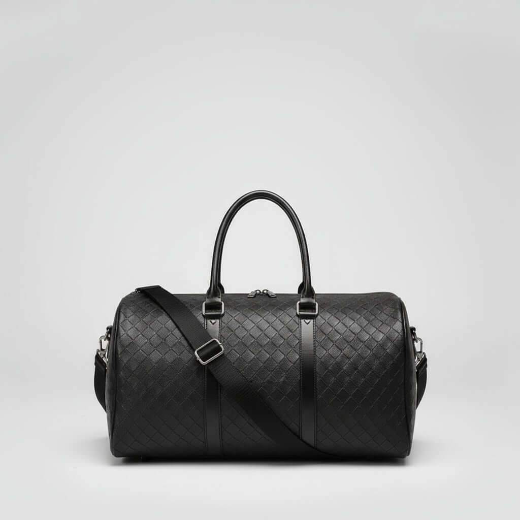 Travel Duffle Bag in black with diamond lattice pattern and adjustable shoulder strap.