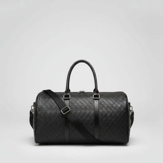 Travel Duffle Bag in black with diamond lattice pattern and adjustable shoulder strap.