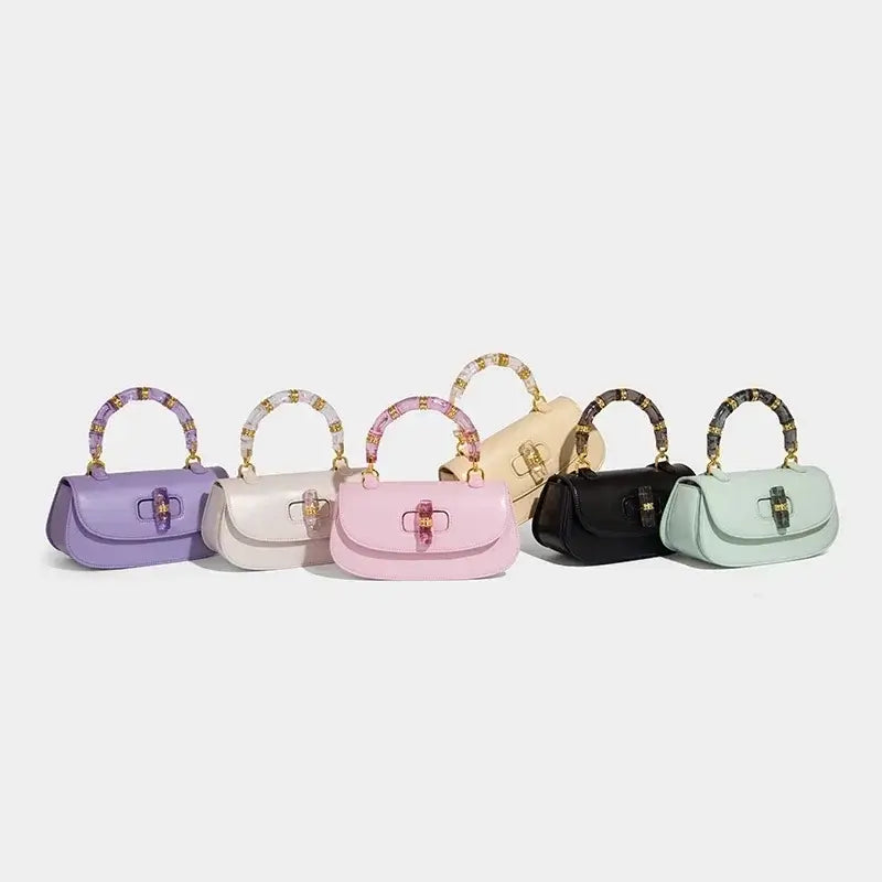 Fashion brand women's handbags in various colors: purple, pink, beige, black, and mint with unique bamboo handles.