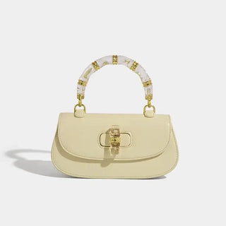 Fashion women's handbag in light yellow with bamboo handle, high-grade leather, and vintage design.