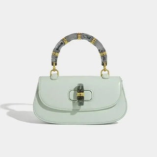 Fashion women's handbag in mint green with bamboo handle, high-grade leather, and elegant design.