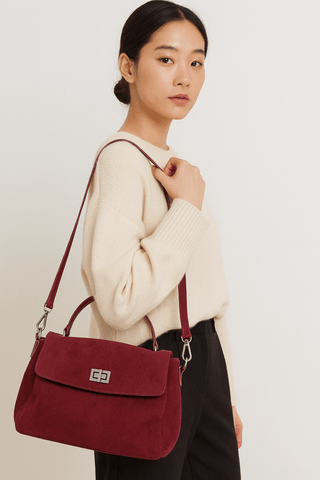 Suede Crossbody Bag worn by model in cream sweater, showcasing its elegant design and rich burgundy color.