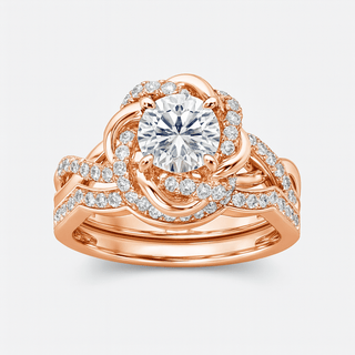 Rose gold ring with a large diamond and smaller diamonds on a light gray background