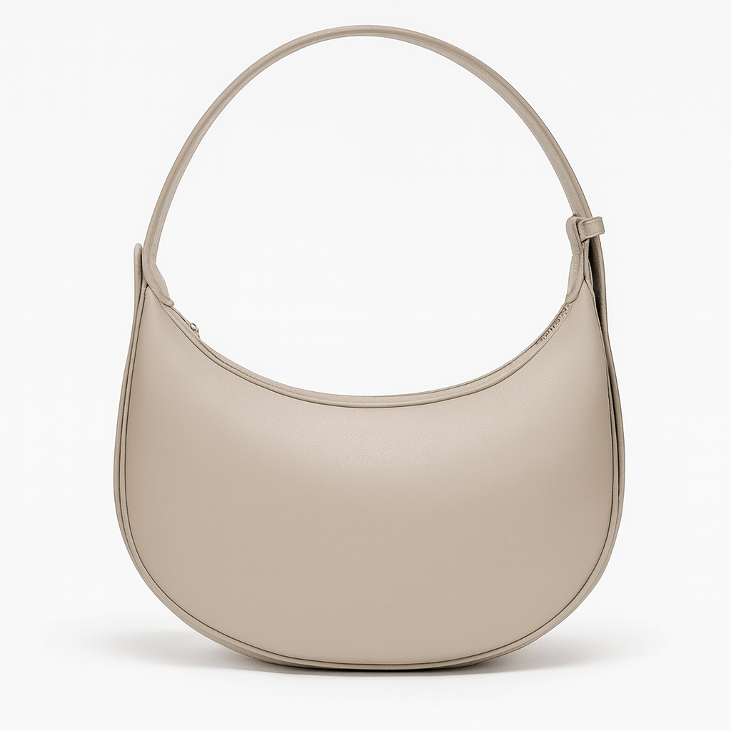 Half Moon Bag in soft beige color with a zipper closure and shoulder strap.