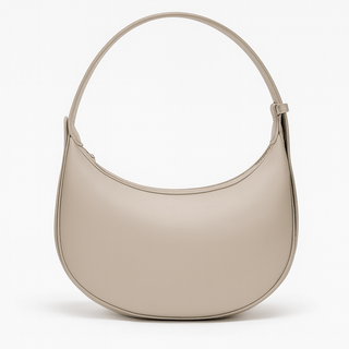 Half Moon Bag in soft beige color with a zipper closure and shoulder strap.