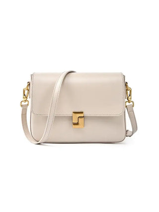 Stylish beige leather shoulder bag with gold clasp and adjustable strap for modern elegance.