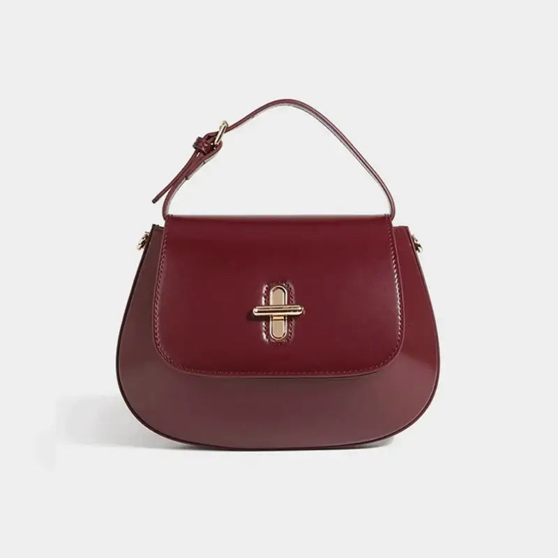 Shoulder bag leather in burgundy color, featuring a decorative lock and structured design, perfect for casual and refined looks.