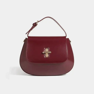 Shoulder bag leather in burgundy color, featuring a decorative lock and structured design, perfect for casual and refined looks.