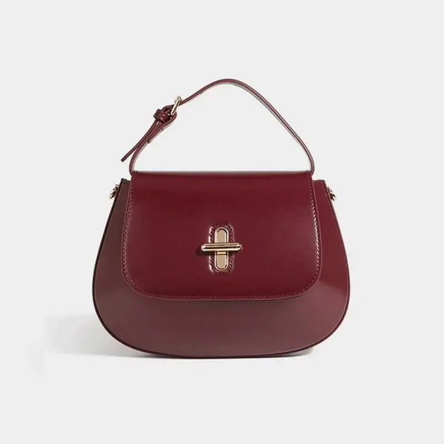 Shoulder bag leather in burgundy color, featuring a decorative lock and structured design, perfect for casual and refined looks.