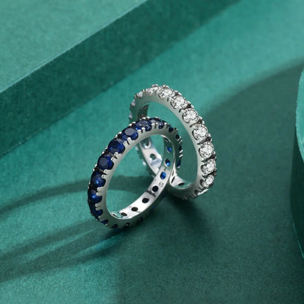 Classic Round Zircon Ring 925 Sterling Silver alongside two elegant band rings.