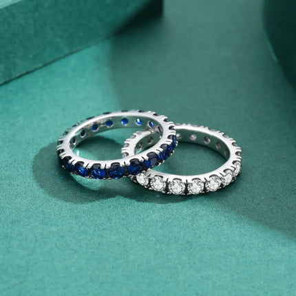 Classic Round Zircon Ring 925 Sterling Silver showcasing two elegant rings, one adorned with blue stones and the other with clear zircon.