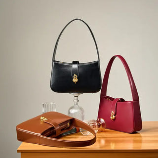 Shoulder Bag Leather - Zipper, black and burgundy half-moon bags with decorative locks and structured design.