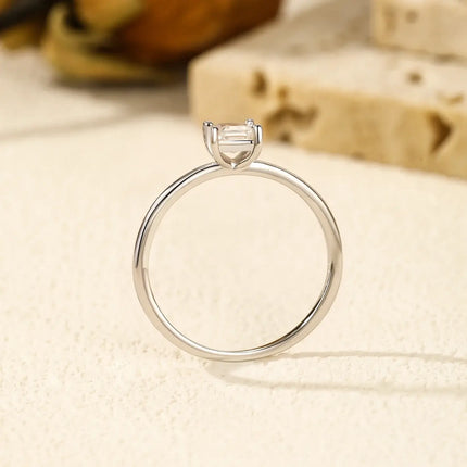 Emerald Cut Moissanite Ring on display, featuring a classic prong setting in 925 sterling silver.