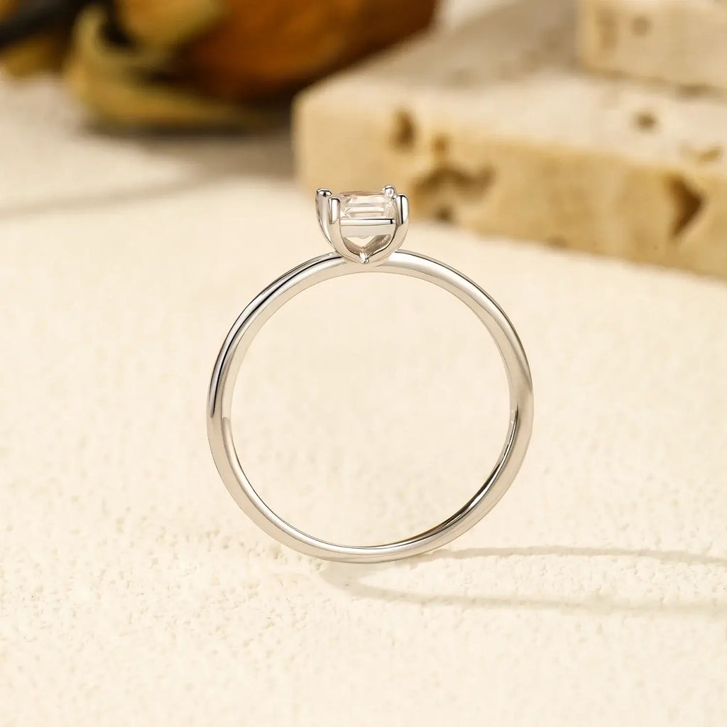 Emerald Cut Moissanite Ring on display, featuring a classic prong setting in 925 sterling silver.