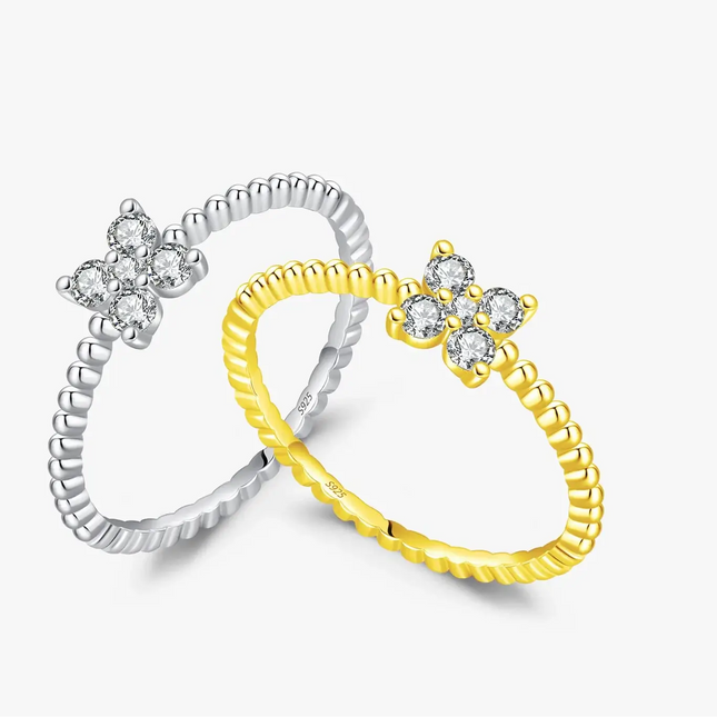 Four Leaf Clover Moissanite Ring 925 Sterling Silver in silver and gold designs with sparkling stones.