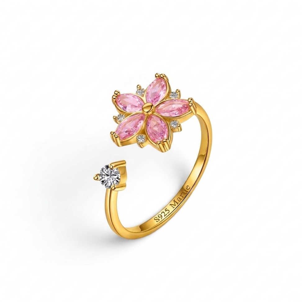 Gold ring with pink gemstones and a diamond on a white background