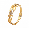 Gold bracelet with leaf-like design on a white background