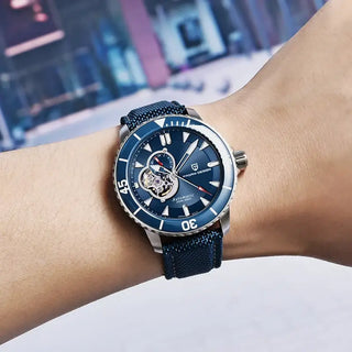 Mens Wristwatch Waterproof with blue dial and nylon strap worn on wrist.
