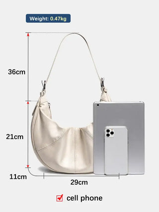 Handmade women’s genuine leather hobo shoulder bag in cream color, showcasing spacious design and light weight.