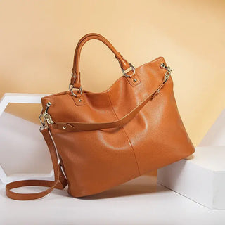 Handmade women’s genuine leather tote bag in orange, stylish shoulder bag with spacious design and secure zipper.