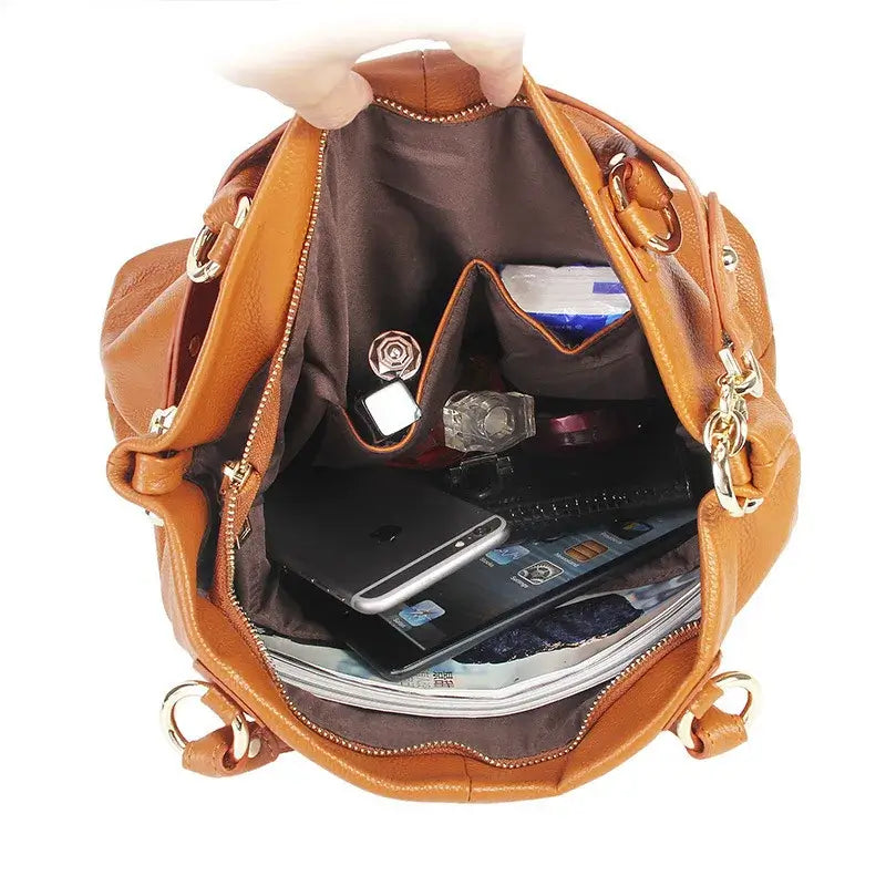 Inside view of a handmade women's genuine leather tote bag in brown, showcasing spacious compartments and organized interior.