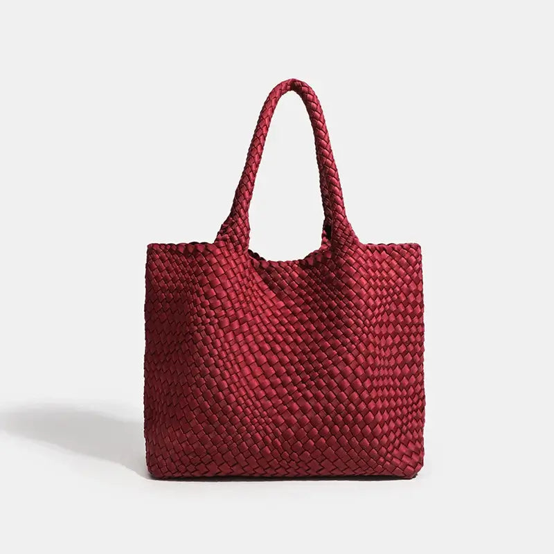 Woven shoulder bag in red, featuring a stylish criss-cross pattern and two sturdy handles, perfect for everyday use.
