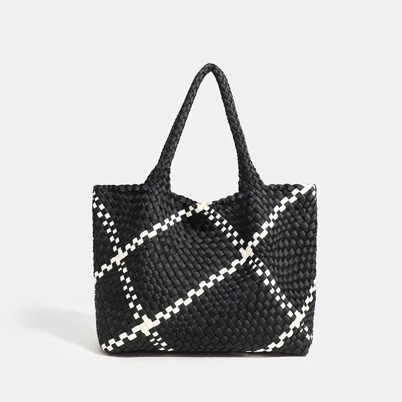Woven shoulder bag in black with white criss-cross pattern, featuring a flap pocket for added functionality.