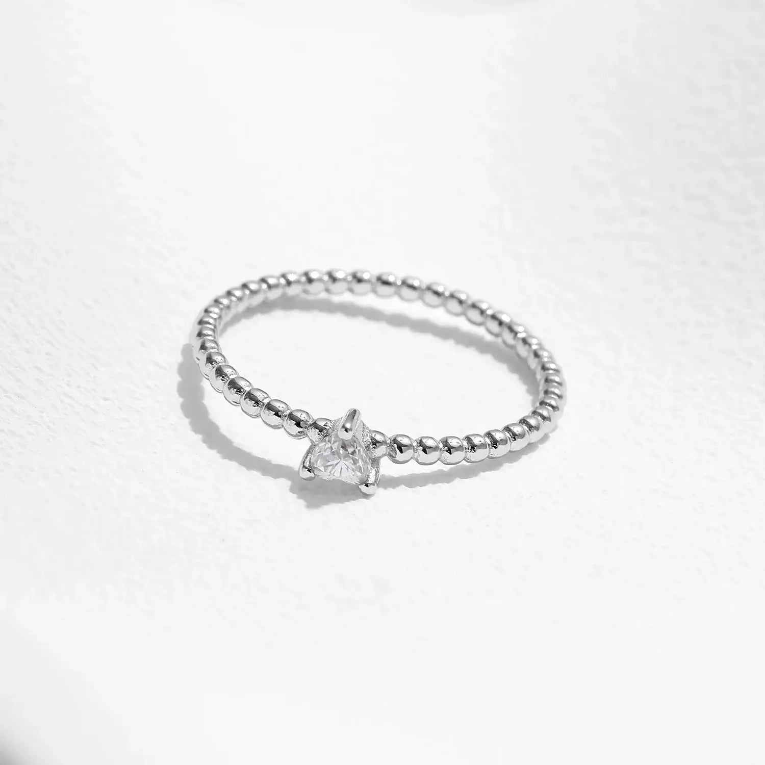Heart Moissanite Engagement Rings featuring a heart-shaped moissanite in a beaded sterling silver band.