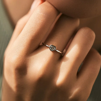 Heart shape Cut Moissanite Solitaire Wedding Ring worn on finger, showcasing its elegant design and intricate detailing.
