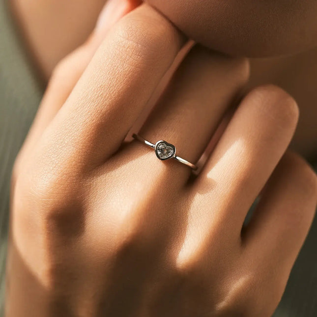 Heart shape Cut Moissanite Solitaire Wedding Ring worn on finger, showcasing its elegant design and intricate detailing.