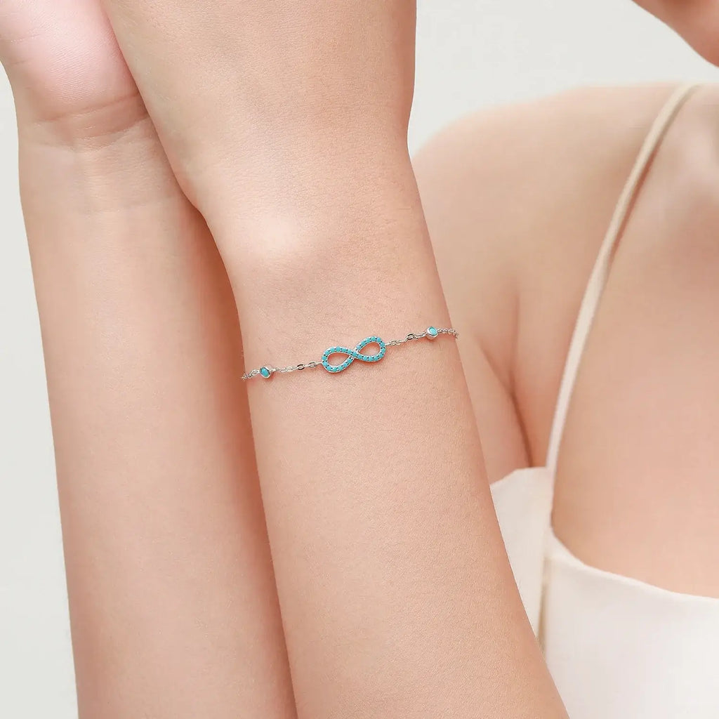 Model wearing Infinite Love Bracelet 925 Sterling Silver with turquoise and crystal accents.