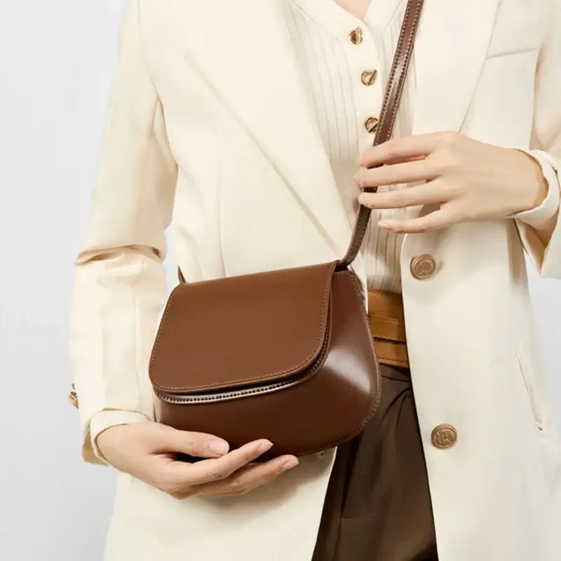 Versatile brown leather shoulder bag, crafted from genuine leather, perfect for casual or elegant occasions.