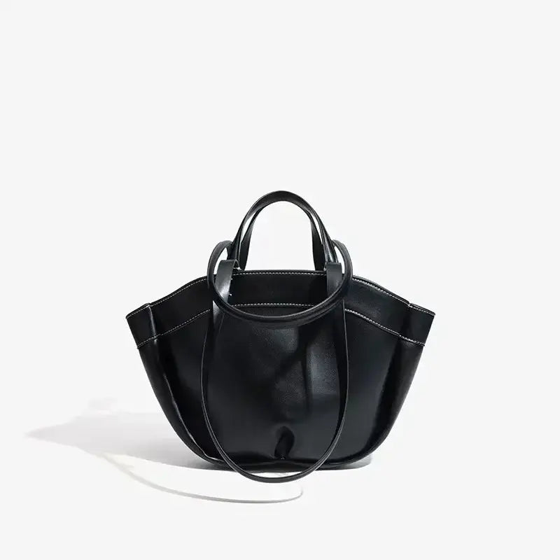 Black tote bag with soft leather finish and dual handles, ideal for casual outings and everyday use.