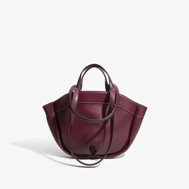 Burgundy large capacity tote bag made of soft synthetic leather for stylish commuting and shopping.