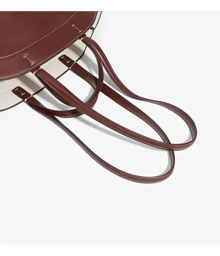 Large capacity brown tote bag with soft synthetic leather, stylish shoulder straps for commuting and shopping.