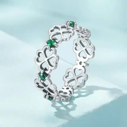 Lucky Cocktail Ring 925 Sterling Silver Zircon with green stones and floral design on a light blue background.