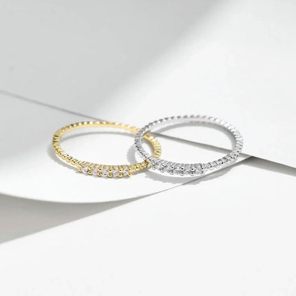 Moissanite Eternity Band Ring in 925 Sterling Silver with elegant design and sparkling stones on a minimalistic background.