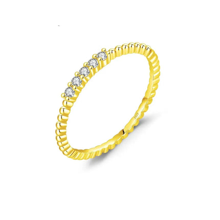 Moissanite Eternity Band Ring in 925 Sterling Silver with round stones in a gold band setting.
