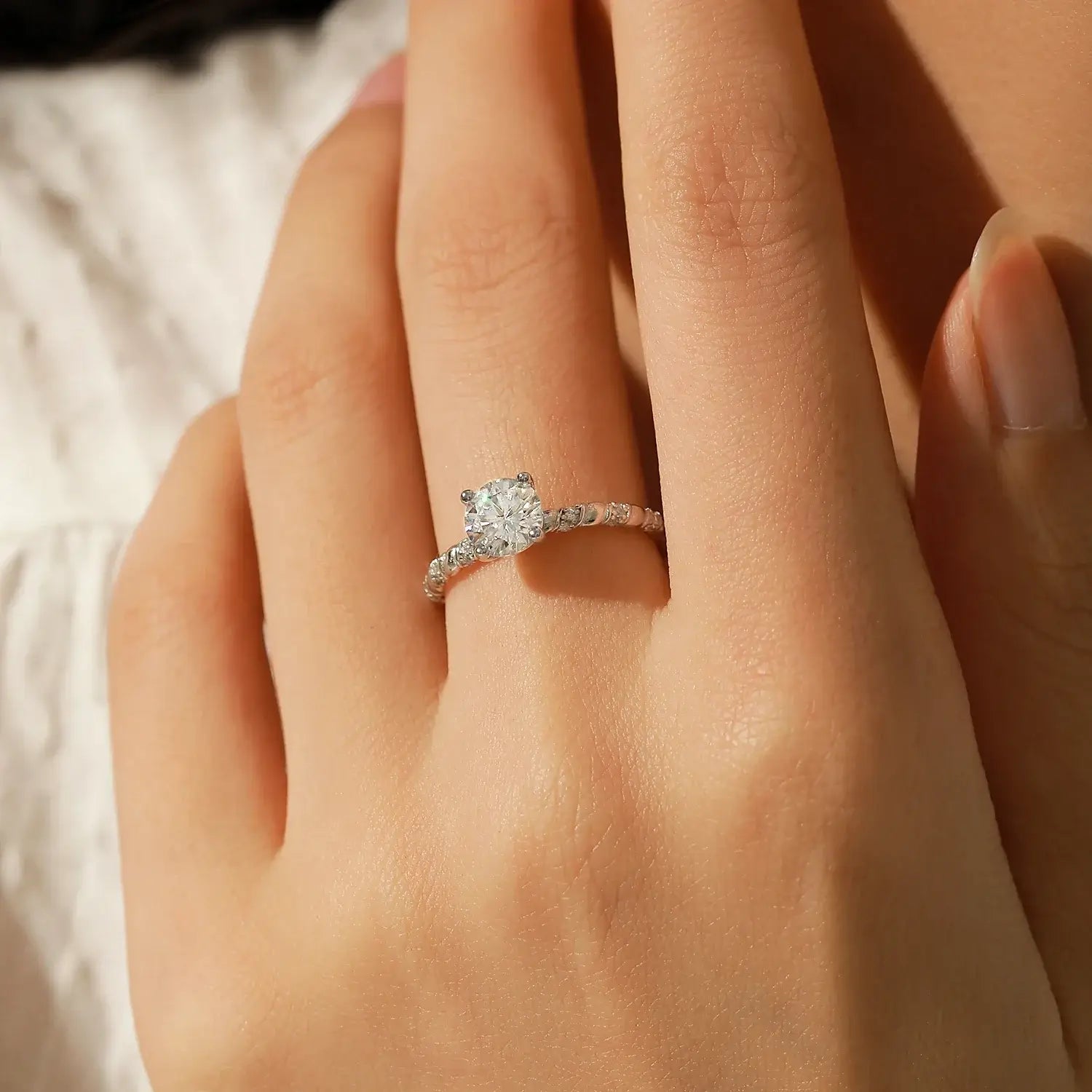 Moissanite Twist Ring in 925 Sterling Silver worn on a hand, showcasing its brilliance and elegant design.