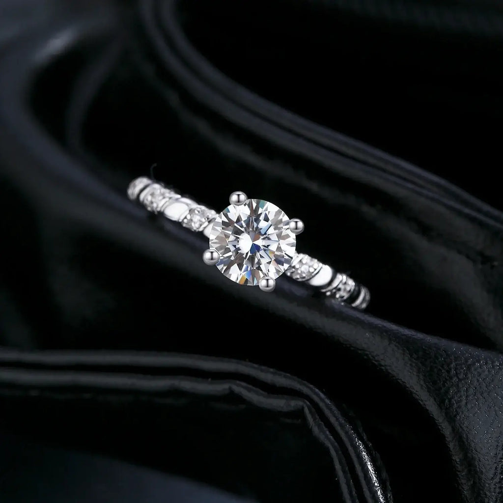 Moissanite Twist Ring in 925 Sterling Silver featuring a dazzling round-cut moissanite in a refined prong setting.