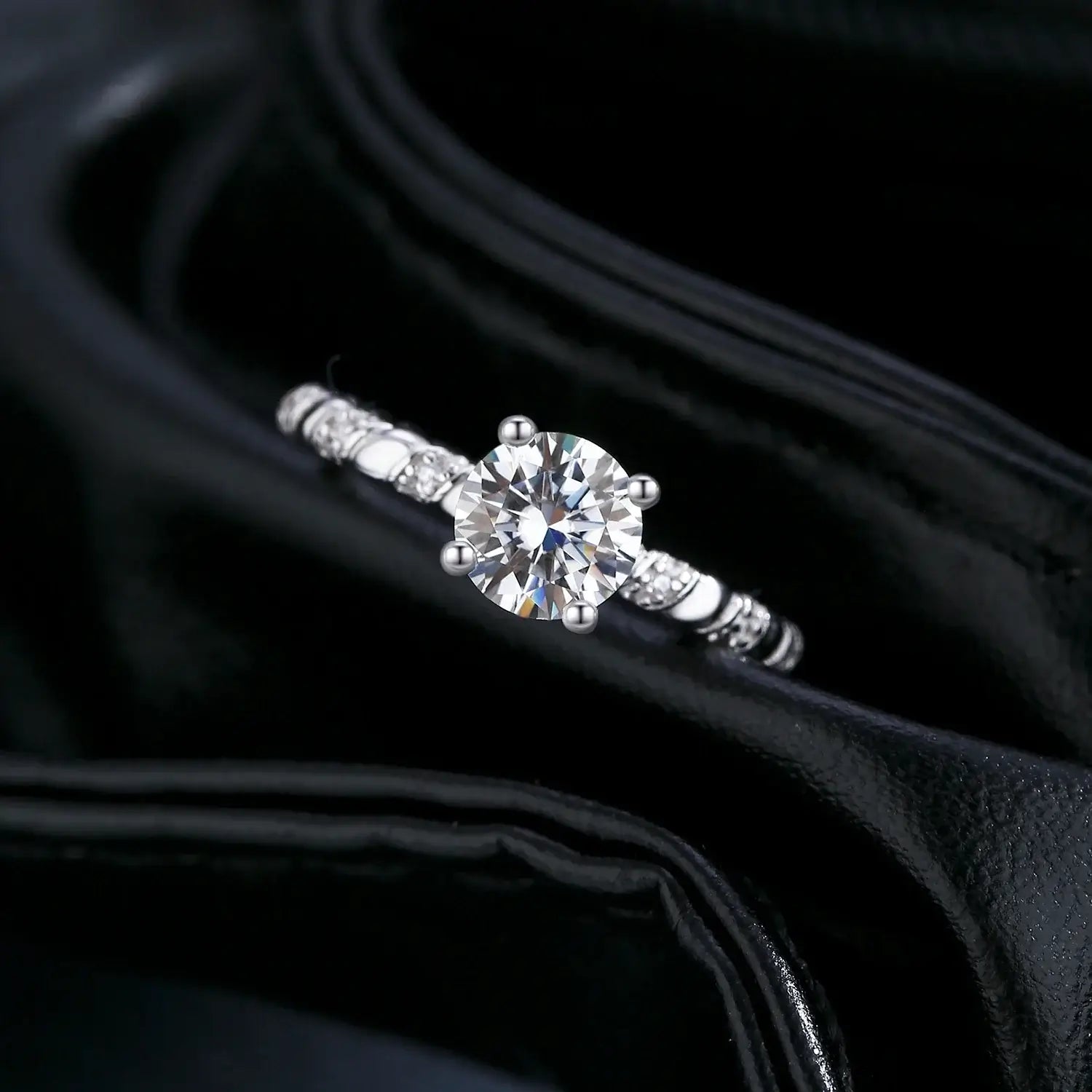 Moissanite Twist Ring in 925 Sterling Silver featuring a dazzling round-cut moissanite in a refined prong setting.