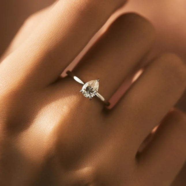 Pear Cut Moissanite Ring 925 Sterling Silver worn on a finger, showcasing its elegant design and sparkling moissanite stone.