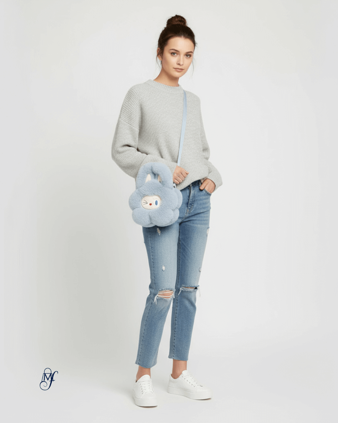Model showcasing the Labubu Handbag in a stylish outfit with a cozy sweater and ripped jeans.