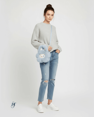 Model showcasing the Labubu Handbag in a stylish outfit with a cozy sweater and ripped jeans.