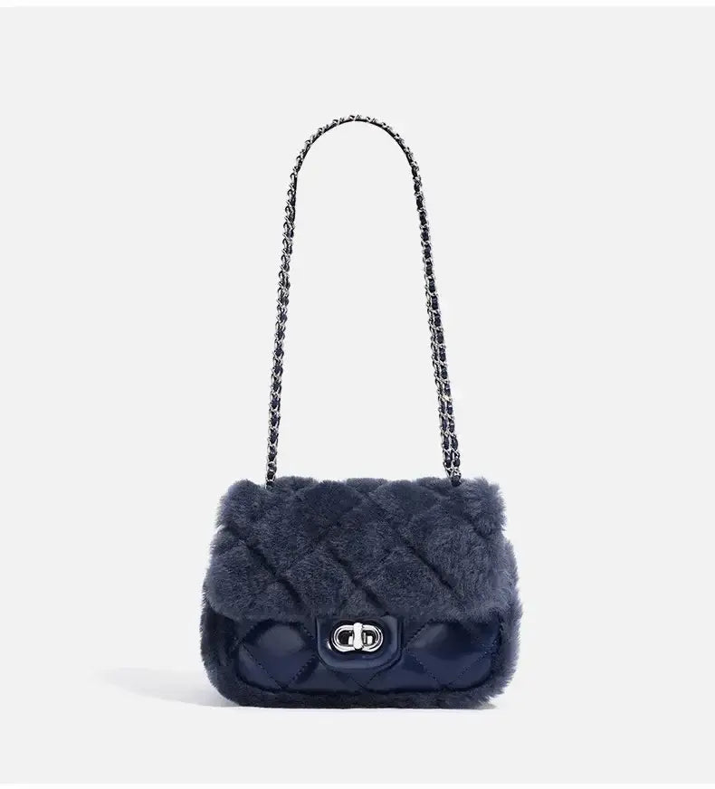 Elegant navy blue faux fur handbag with chain strap, quilted design, perfect for stylish outings.