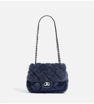Elegant navy blue faux fur handbag with chain strap, quilted design, perfect for stylish outings.