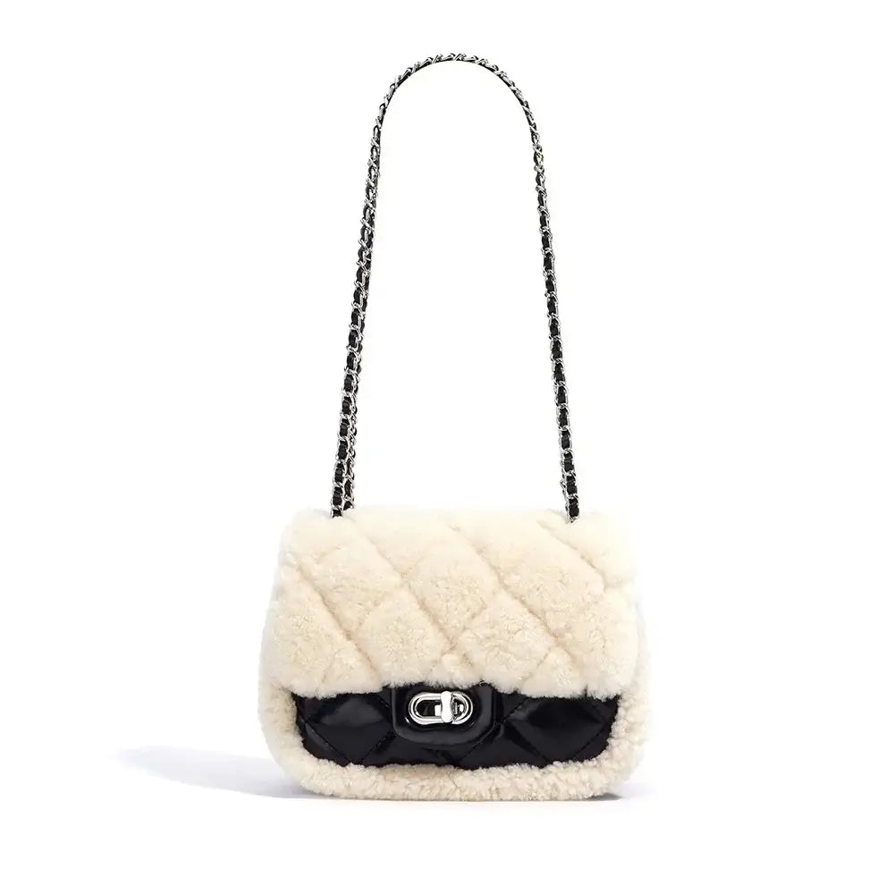 Elegant cream-colored handbag with a quilted design and black satin strap, perfect for stylish crossbody wear.