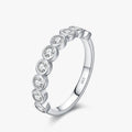 Round Moissanite Eternity Ring 925 Sterling Silver featuring multiple moissanite stones in a sleek bezel setting.