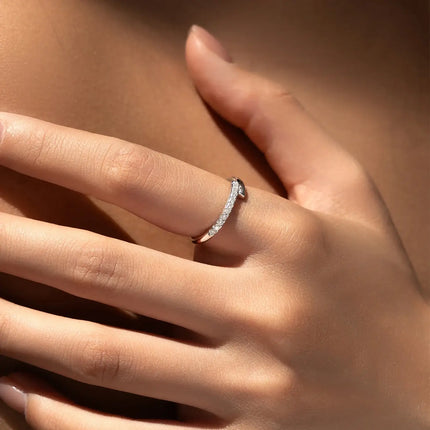 Close-up of a hand wearing a Round Pavé Moissanite Ring, showcasing its elegant pavé setting and sparkle.