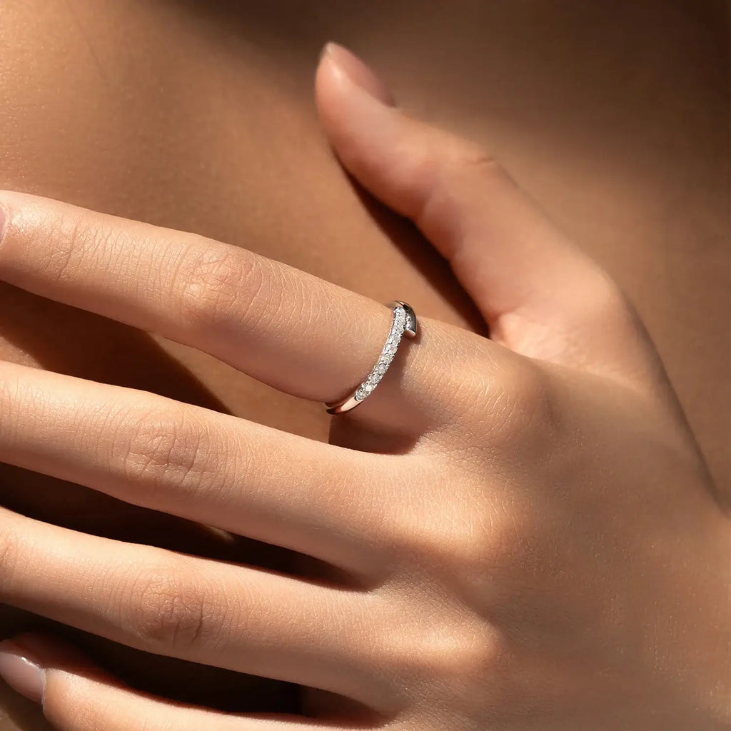 Close-up of a hand wearing a Round Pavé Moissanite Ring, showcasing its elegant pavé setting and sparkle.